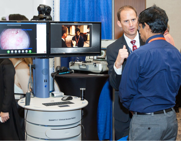 A service provider demonstrates telemedicine technology for an attendee.