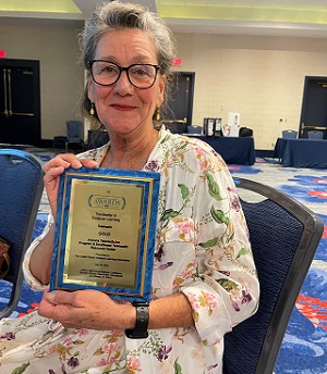 Janet Major, Arizona Telemedicine Program and Southwest Telehealth Resource Center’s associate director for Innovation and Digital Health, holding ATP and SWTRC’s latest award from the USDLA.