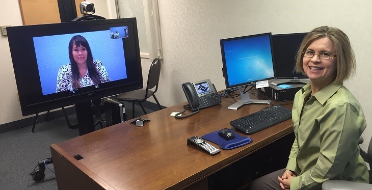Dr. Gibson demonstrates her telemedicine setup with a staff member, circa 2013. Photo courtesy of Health Choice Arizona