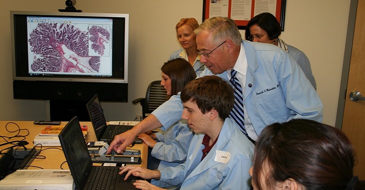 Dr. Weinstein demonstrating telepathology during a teaching session.
