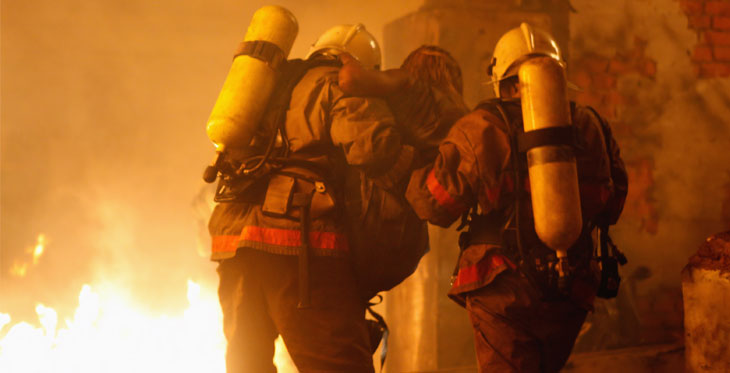 fireman rescuing burn victim